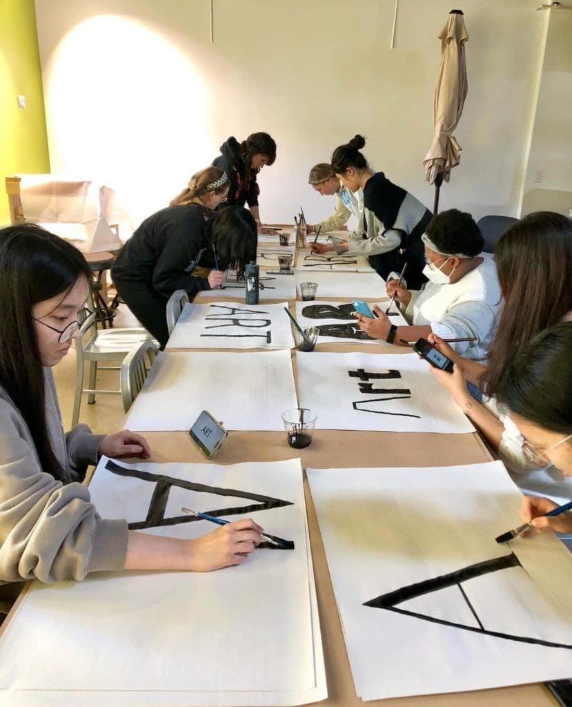 Image of students working on typography assignment 